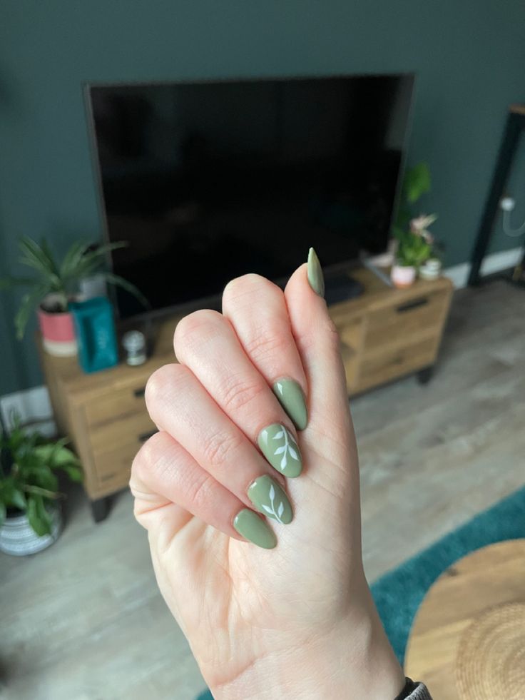 Chic Nature-Inspired Nail Design: Stylish Green Matte Finish with Delicate Leaf Art