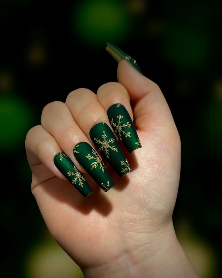 Elegant Matte Green Nails with Gold Snowflakes: A Sophisticated Winter Aesthetic for Holiday Festivities.