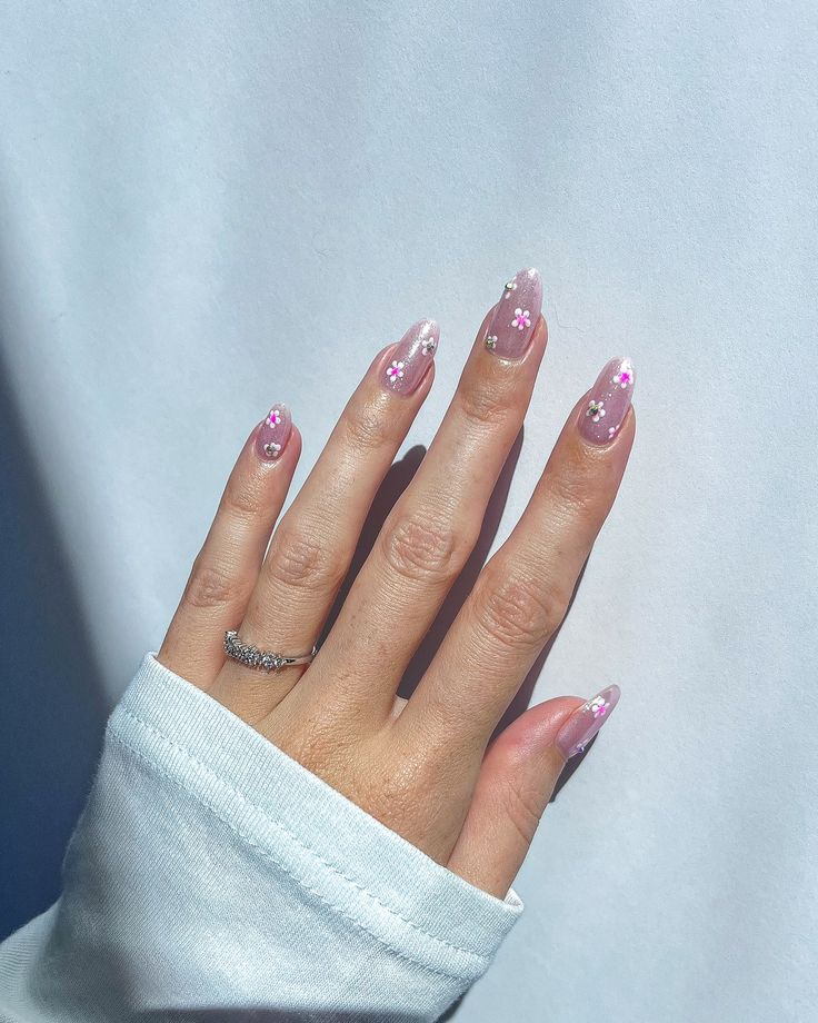 Charming Floral Nail Art with Soft Pink Gradient and Sparkling Accents.