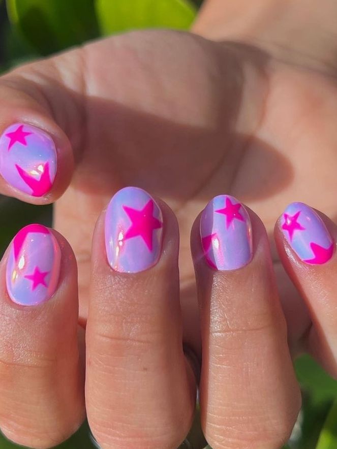 Playful Star-Themed Nail Design with Vibrant Pink Stars on a Lavender-Blue Gradient Background.