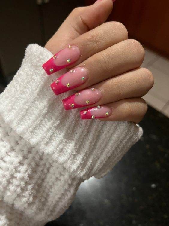 Chic Vibrant Pink Ombre Nails with Gold Star Accents.