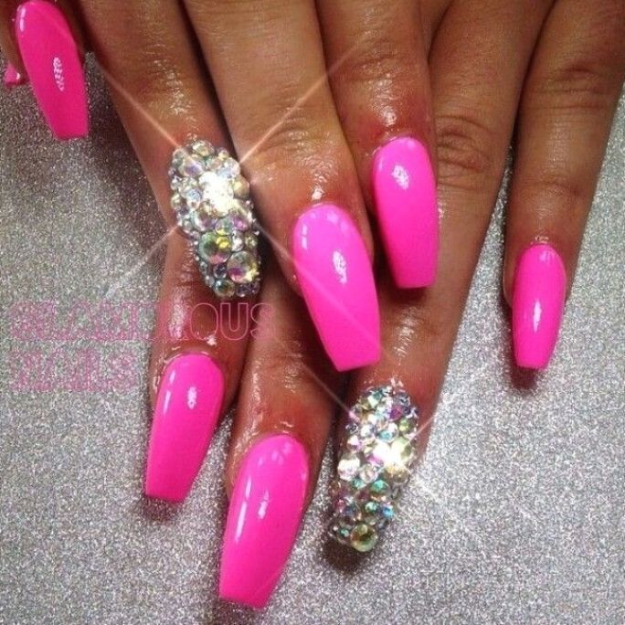 Bold Pink Almond Nails with Glamorous Rhinestone Accents for a Playful Aesthetic.