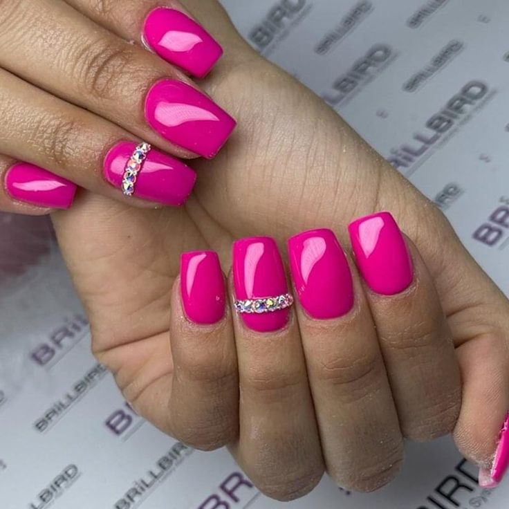 Bold Pink Glossy Nails with Glamorous Rhinestone Accents and Modern Square Tips.