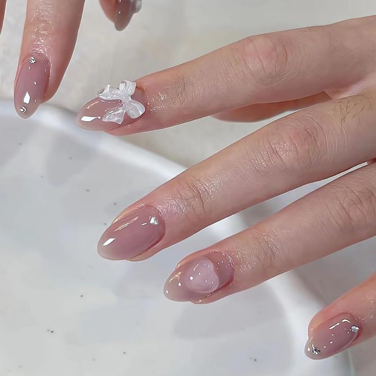 Chic Nude Nail Design with Glossy French Tips and Delicate Floral Accents.