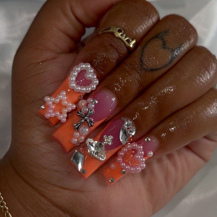 Playful Vibrant Nail Art: Bright Orange and Pink with Embellishments