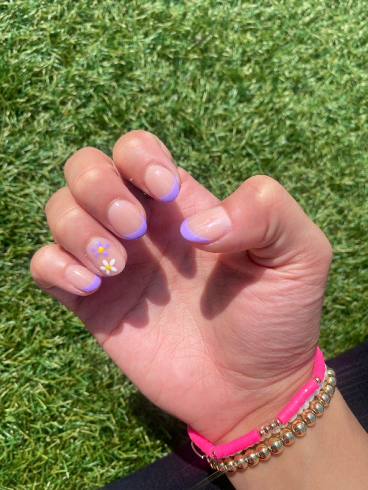 Vibrant Lavender-Tipped Nail Design with Playful Flower Accents for a Fresh Spring Look.