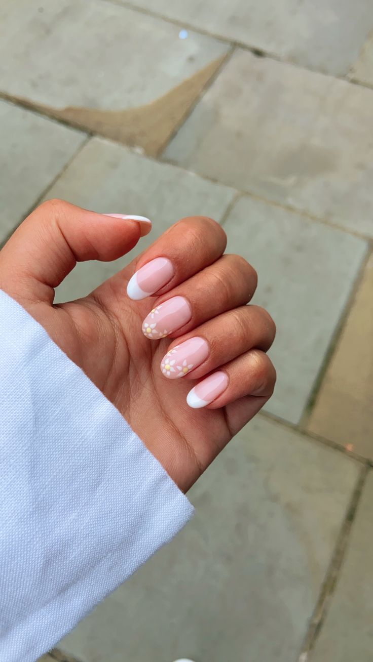 Charming Soft Pink and White Nail Design with Floral Accents.