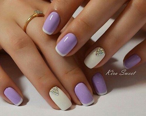 Sophisticated Lavender and White Nail Design with Glossy Finishes and Rhinestone Accents.