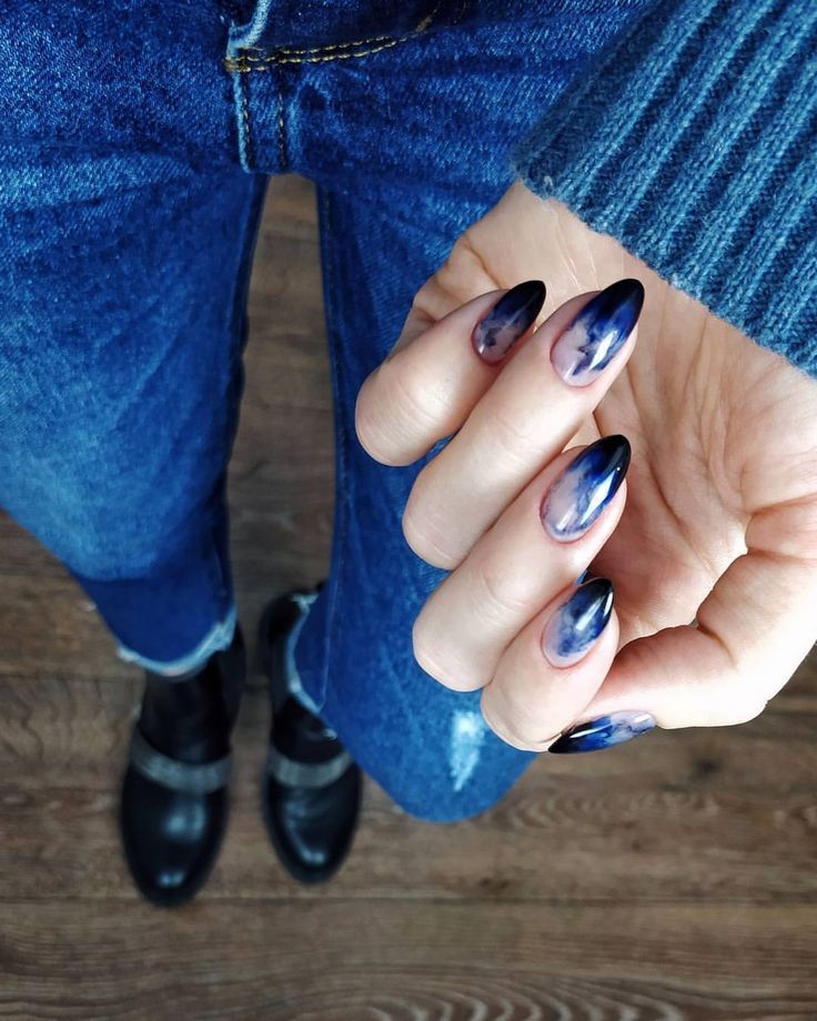 Sophisticated Gradient Nail Design in Deep Blues and Purples Complements Casual Denim.