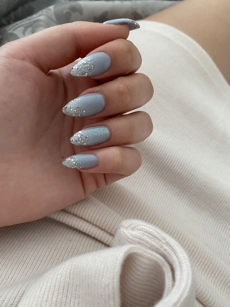 Chic Pastel Blue Almond Nails with Sparkling Silver Accents for Elegant Versatility.