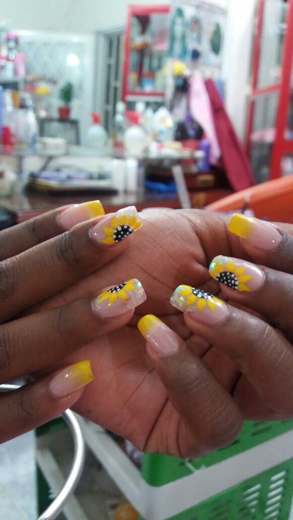 Vibrant Summer Nail Design with Cheerful Sunflower Motifs and Bold Yellow Tips.