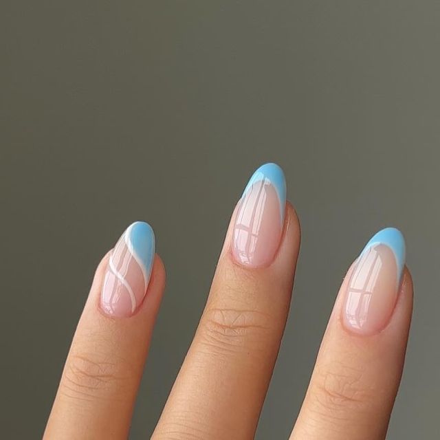 Chic Pastel Nail Design: A Fresh Blend of Light Blue and Nude with Artistic Patterns