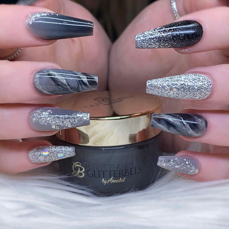 Chic Gray and Silver Nail Design with Intricate Patterns and Glitter Accents.