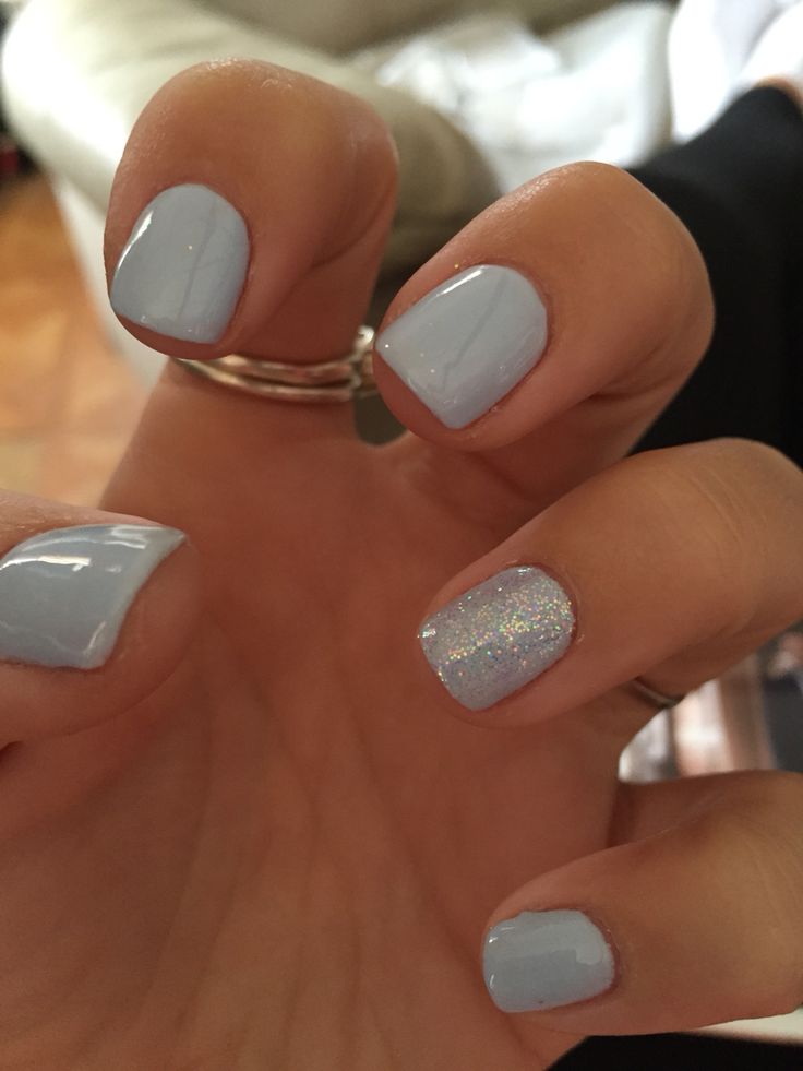 Charming Soft Pastel Nail Design: Pale Blue Base with Shimmering Accent for Elegant Style.