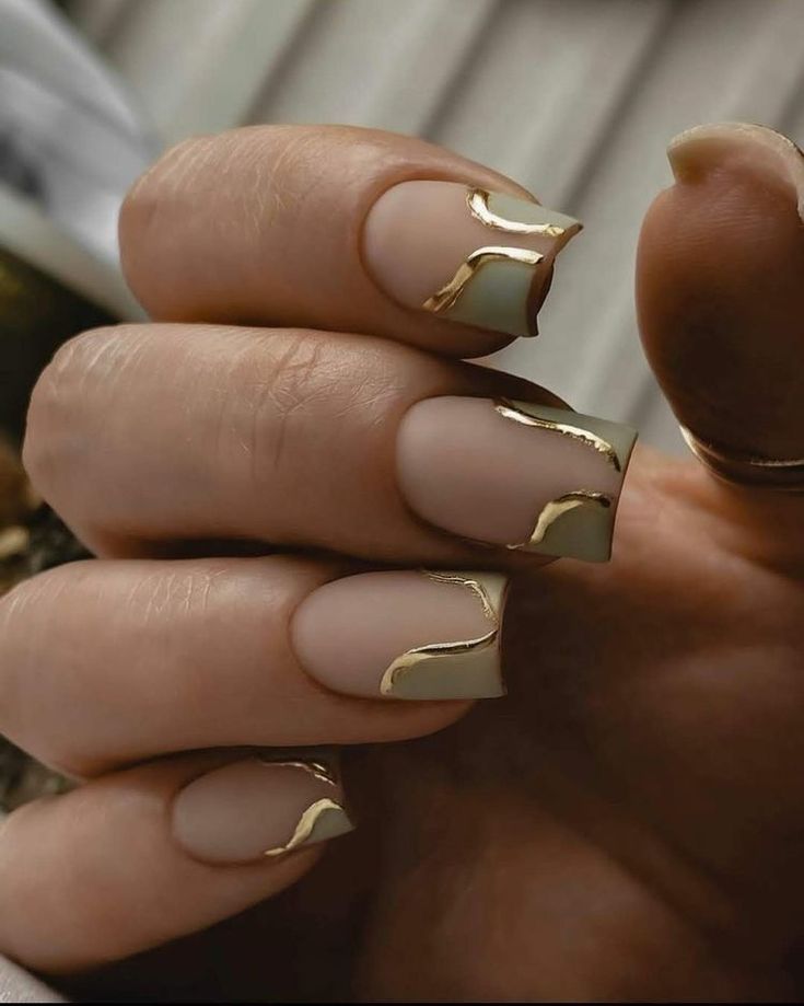 Sophisticated Matte Nail Design with Glossy Gold Accents and Unique Wave Patterns