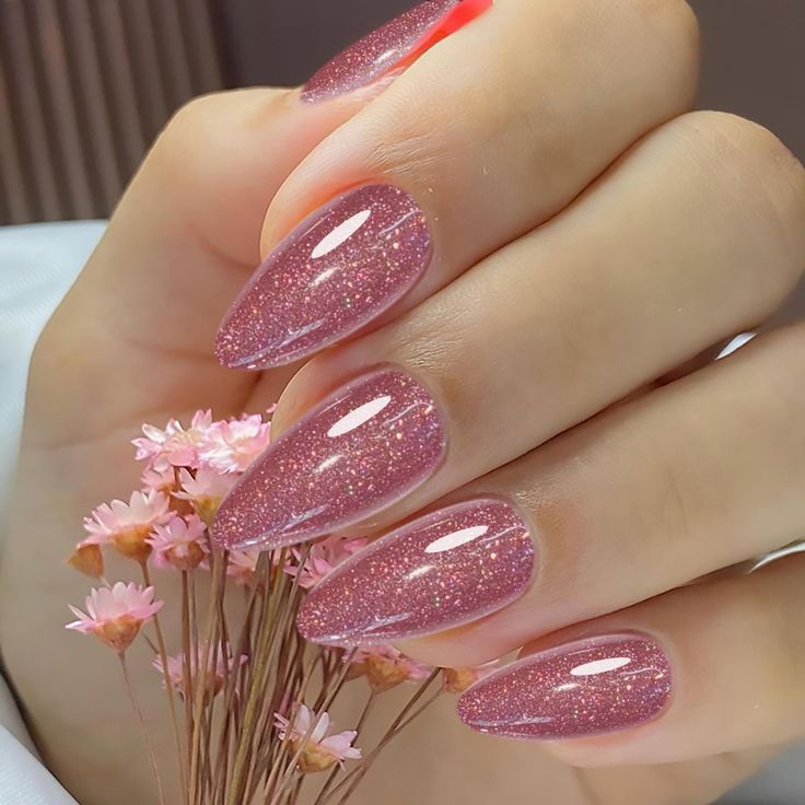 Elegant Glittering Pink Almond-Shaped Nail Design for Any Occasion.