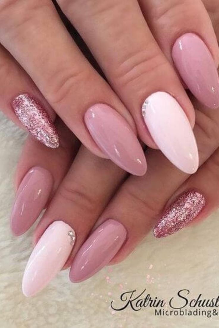 Chic Almond-Shaped Nail Design with Soft Pink Shades and Sparkling Accents.