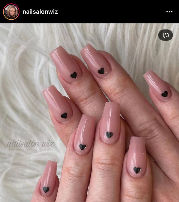 Chic Glossy Nude Nail Design with Playful Heart Accents