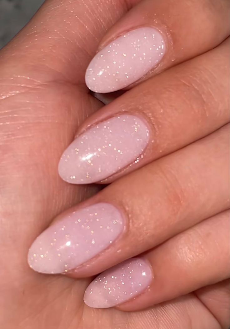 Elegant Sparkly Nude Nail Design with Soft Pink Base and Delicate Shimmer.