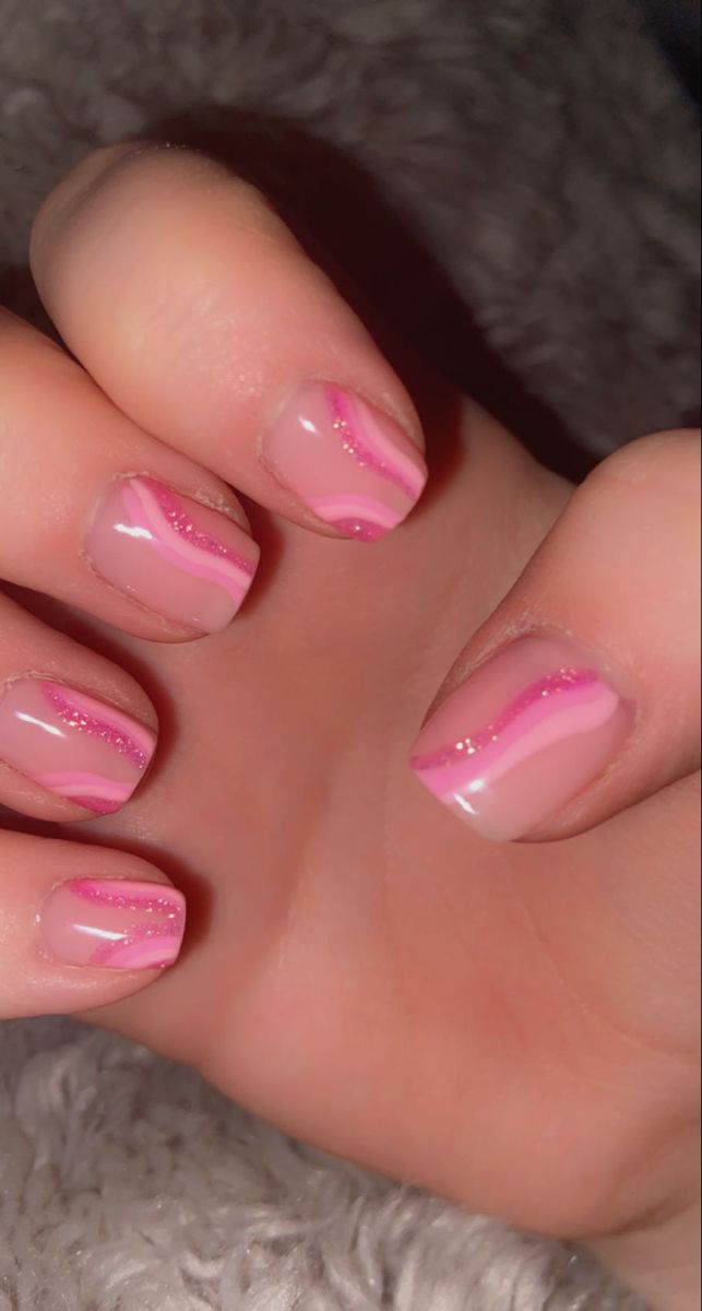 Chic Pink Nail Design: Soft Waves and Glitter for a Playful, Elegant Look.