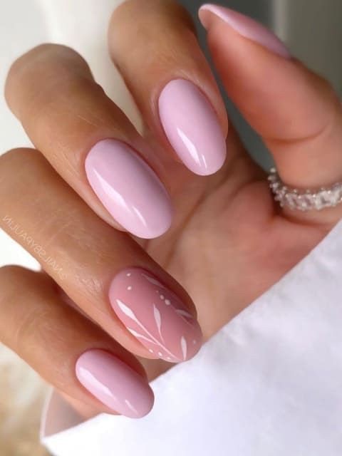 Sophisticated Soft Pink Gradient Nail Design with Artful White Floral Accents.