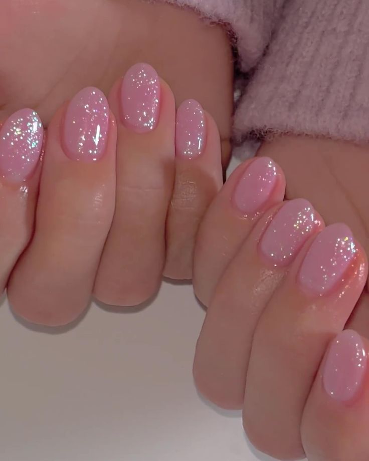 Elegant Sparkling Pink Nails: A Playful Gradient Design with Modern Gloss Finish.