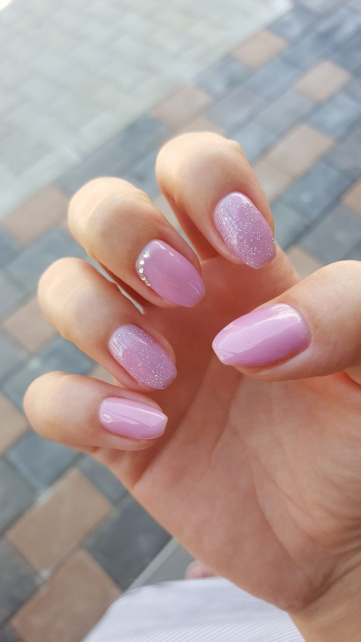 Chic Delicate Pink Nail Design with Glossy and Glitter Accents.