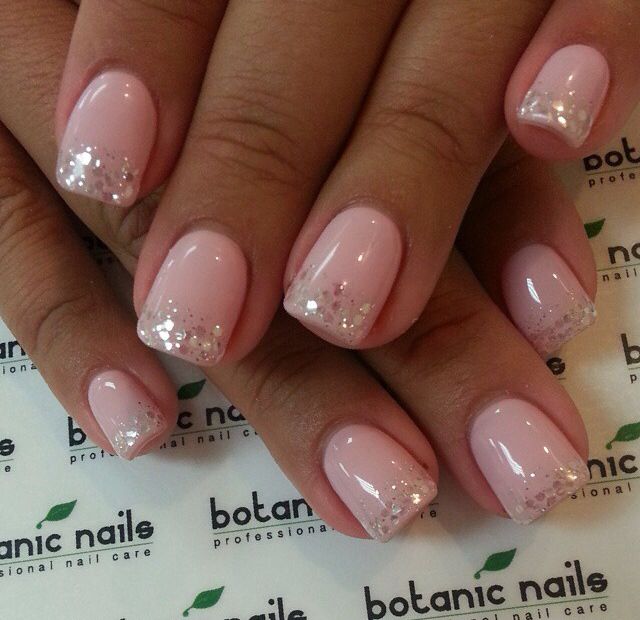 Elegant Soft Pink Nail Design with Glitter Tips for a Polished Look.