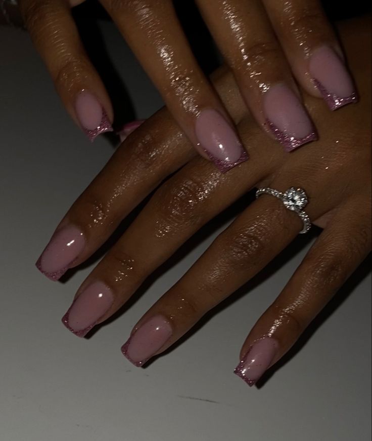 Sophisticated Soft Pink Manicure with Shimmering Tips and Glossy Finish.