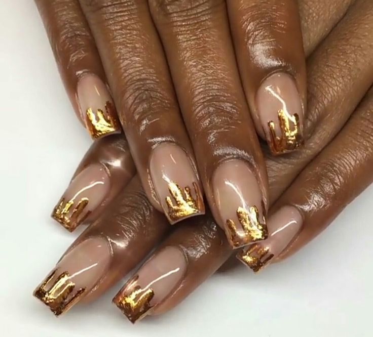 Chic Nude Nails with Glossy Golden Accents: A Sophisticated Modern Twist