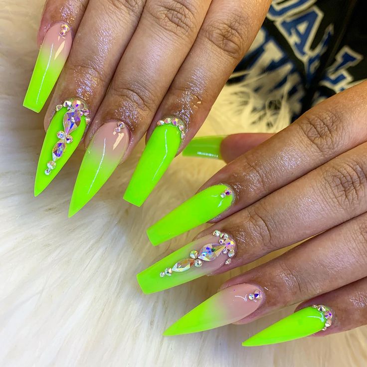 Bold Neon Green Stiletto Nails with Playful Ombre and Dazzling Rhinestones.