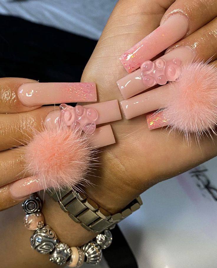 Chic Soft Pink Nail Design with Textured Bubbles and Fluffy Pom-Poms.