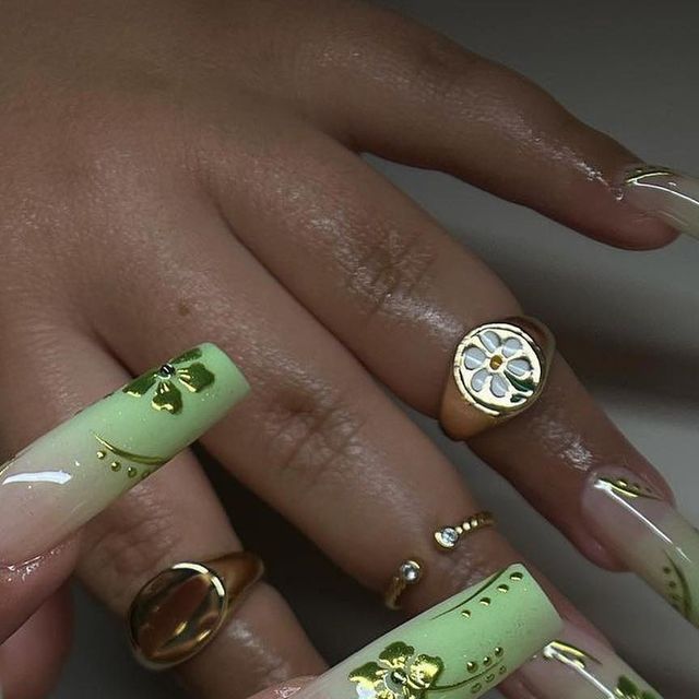 Elegant Green Ombre Nail Design with Gold Accents and Floral Details.