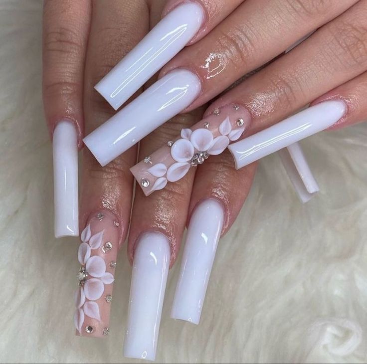 Sophisticated Elegant White Nails Enhanced with Floral Designs and Embellishments.