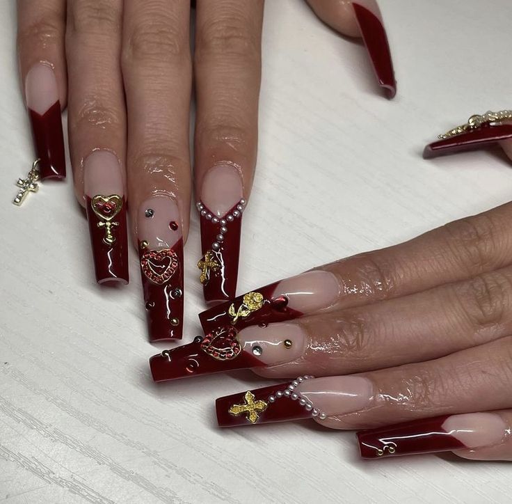 Elegant Burgundy Nail Design with Ornate Embellishments for a Striking Statement.