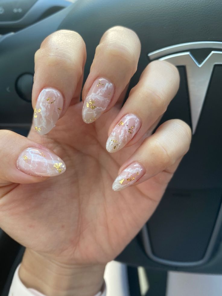 Chic Almond-Shaped Nail Design with Pink and White Marble Effect and Glamorous Gold Flakes