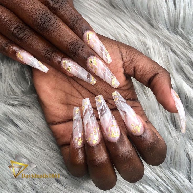 Chic Marble Nail Design with Gold Flakes for a Luxurious Statement.