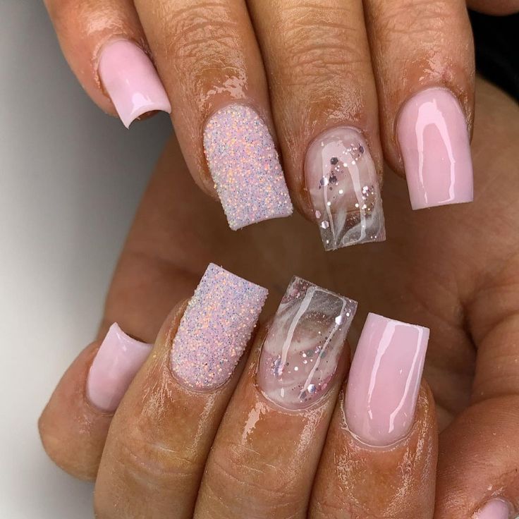 Elegant Soft Pink Nail Design with Textured Finishes and Sparkling Accents.