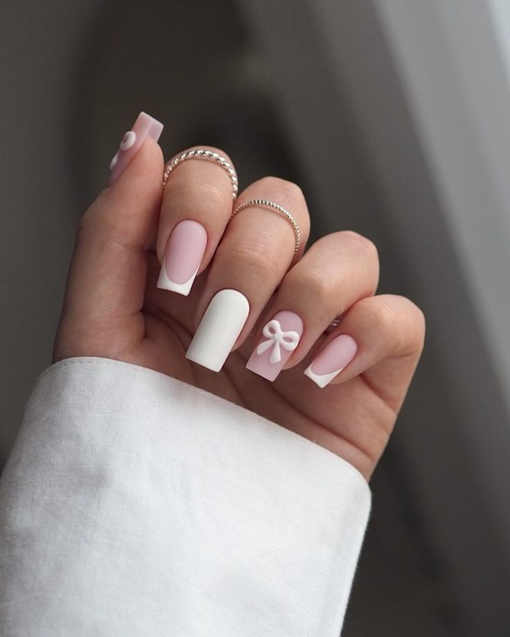 Elegant Soft Pink and White Chic Nail Design with Delicate Bow Accents