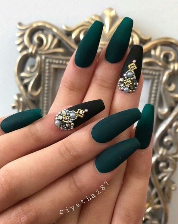 Elegant Almond-Shaped Nail Design with Emerald Green, Matte Black, and Gemstone Embellishments.