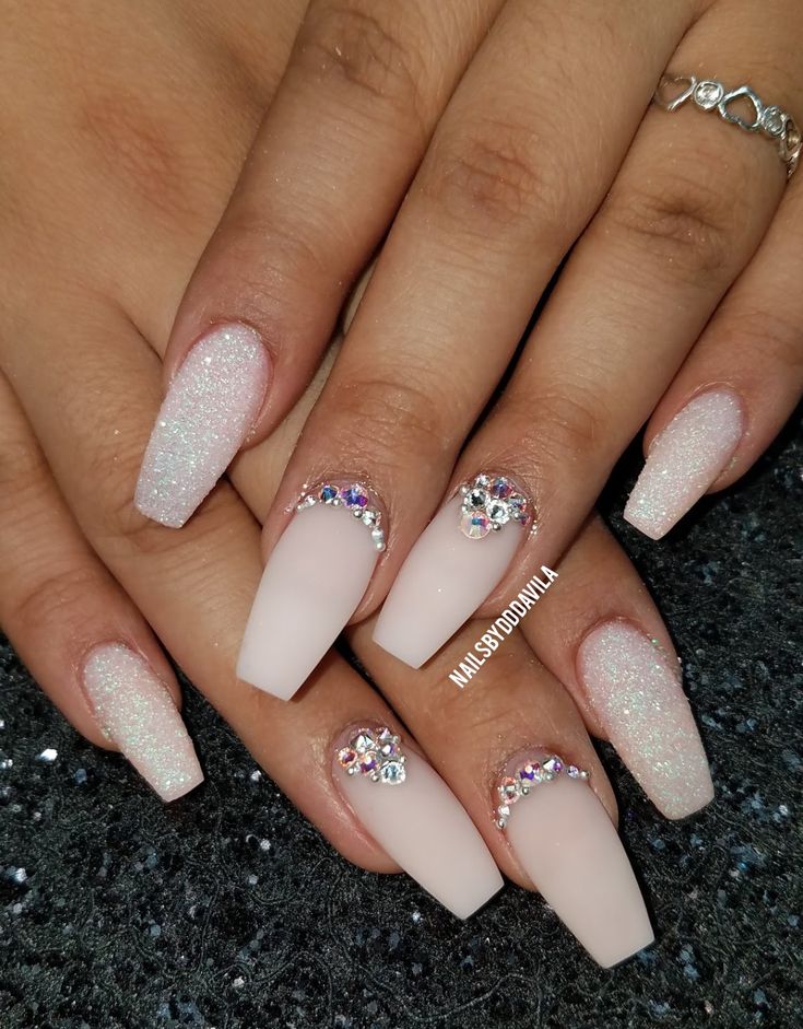 Elegant Matte and Glitter Nail Design with Sparkly Gradient Tips and Rhinestone Accents.