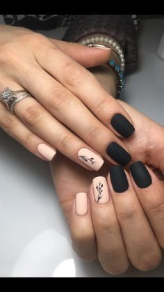 Chic Nail Design: Striking Contrast of Matte Beige and Glossy Black with Botanical Accents