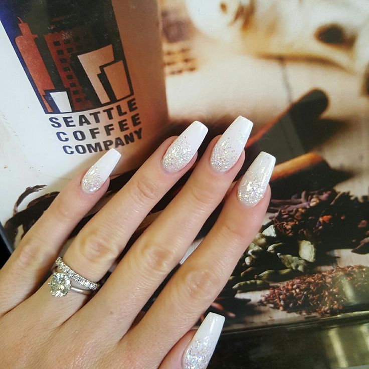 Elegant Long Nails: Striking White Base with Subtle Silver Glitter for a Sophisticated Touch.