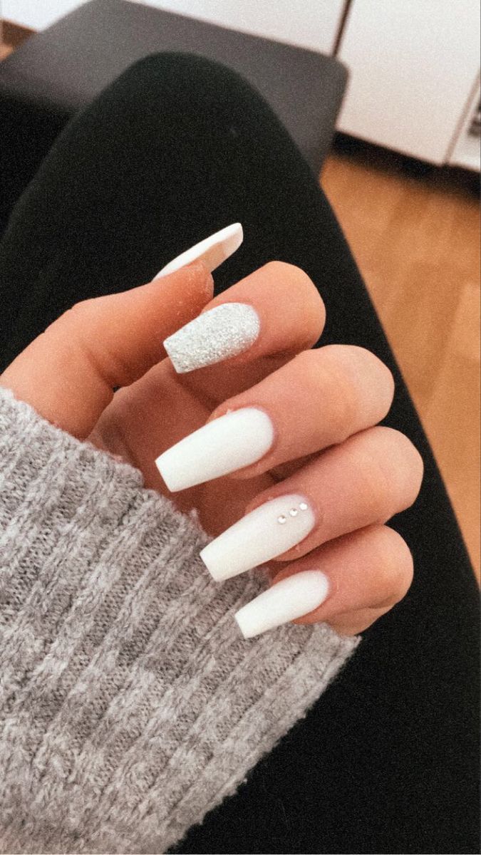 Chic Long Nails: Matte White with Glitter Accents and Crystal Embellishments.