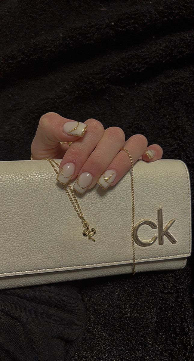 Sophisticated Elegant Nail Design with Subtle French Tips and Gold Accents