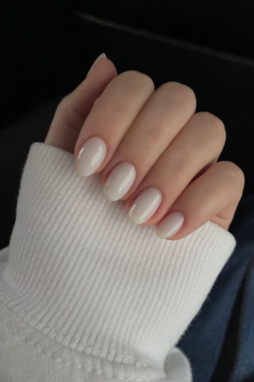 Sophisticated Minimalist Nail Design with Sheer White Polish and Almond Shape.