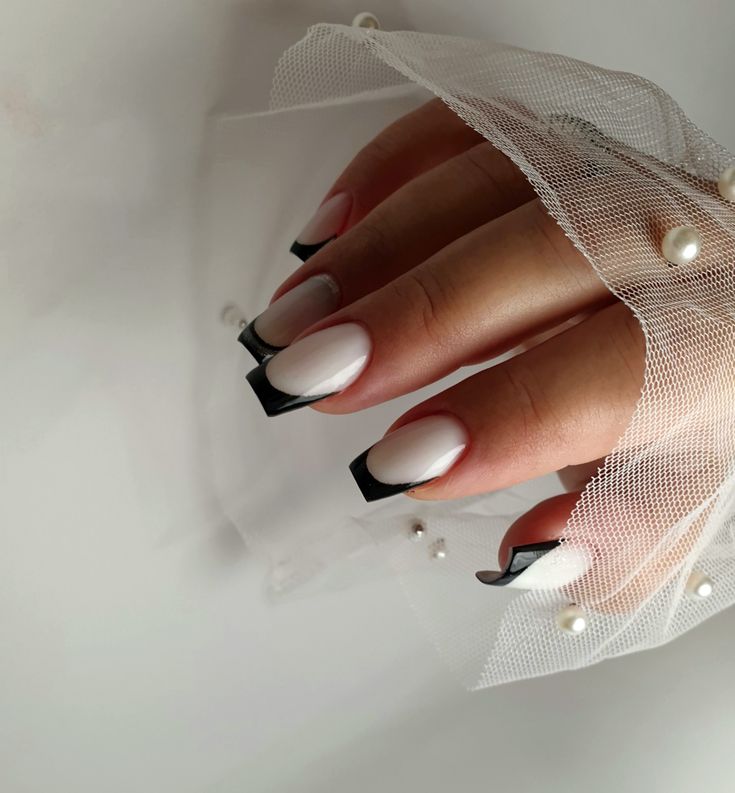 Chic French Manicure: Sleek White Base with Striking Black Tips and Elegant Pearl Accents