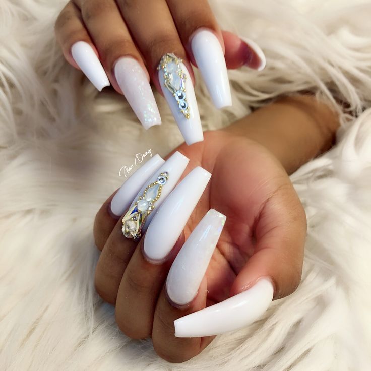 Chic Long Glossy White Nails with Unique Designs and Sparkling Accents.