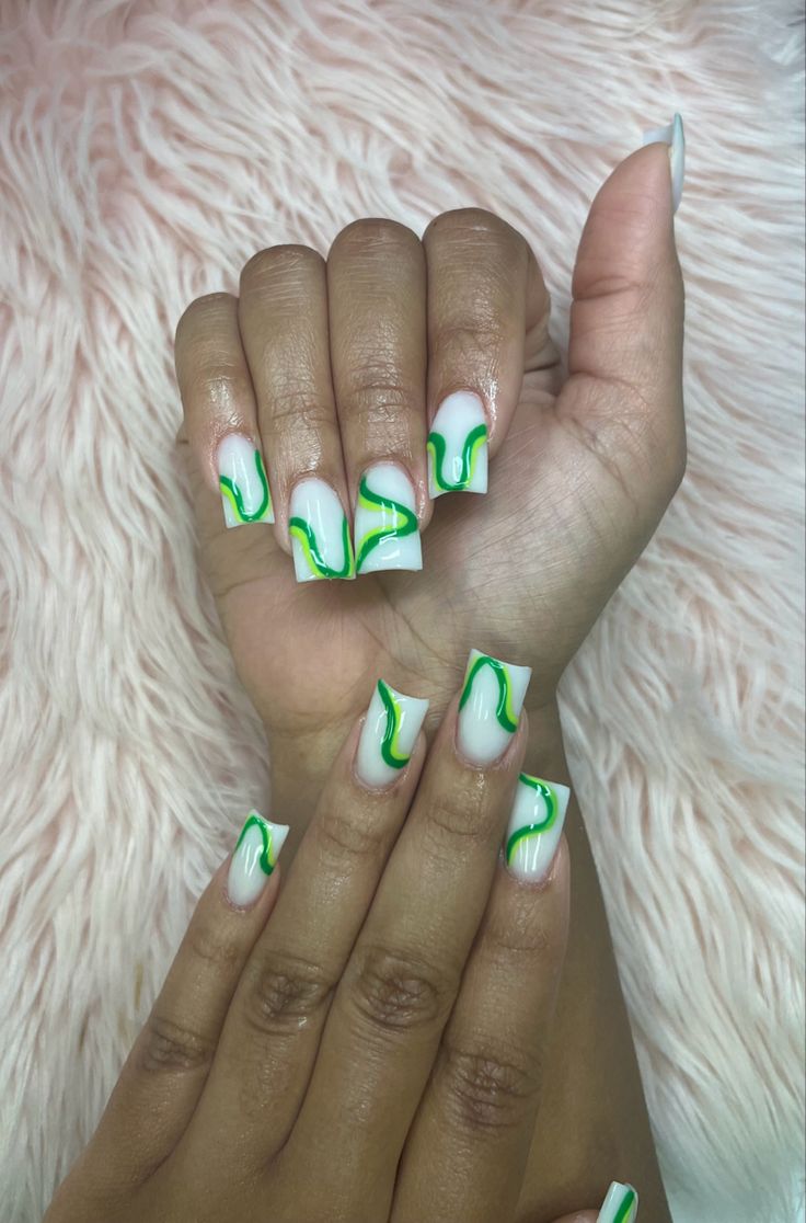 Chic Glossy White and Vibrant Green Swirl Nail Design.