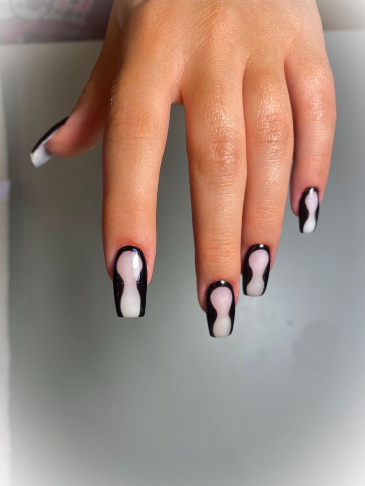 Bold Black and White Wavy Nail Art for a Modern Look.